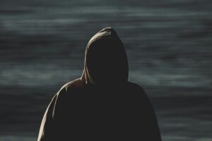 A dark mysterious silhouette of a hooded figure Blogs
